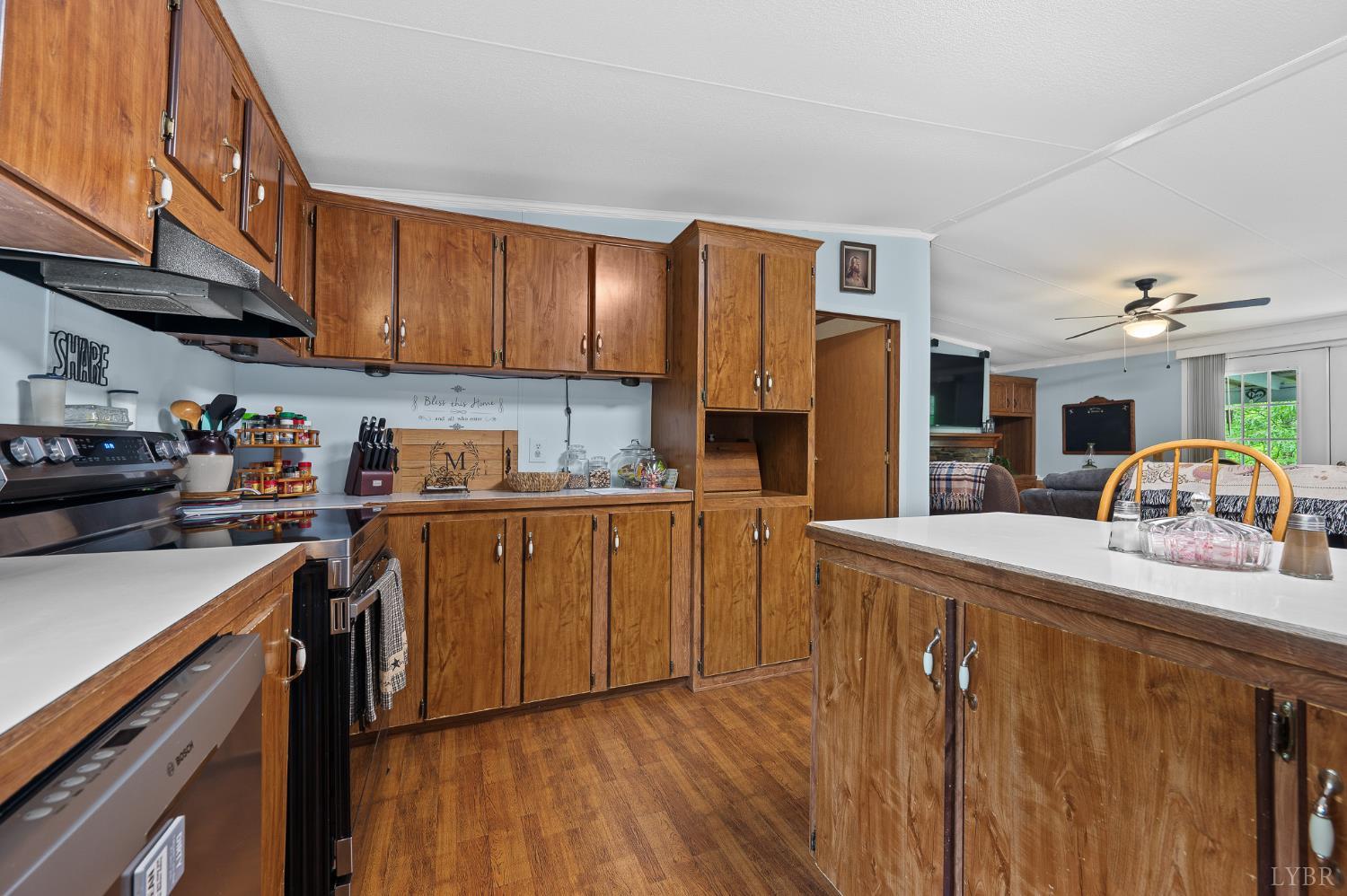 142 Micklem Lane Shipman, VA 22971 - Photo 22 of 38 a kitchen with stainless steel appliances granite countertop a refrigerator a sink dishwasher a stove top oven a dining table and chairs with wooden floor