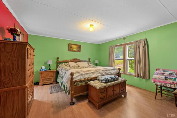 a bedroom with a bed chair and a window