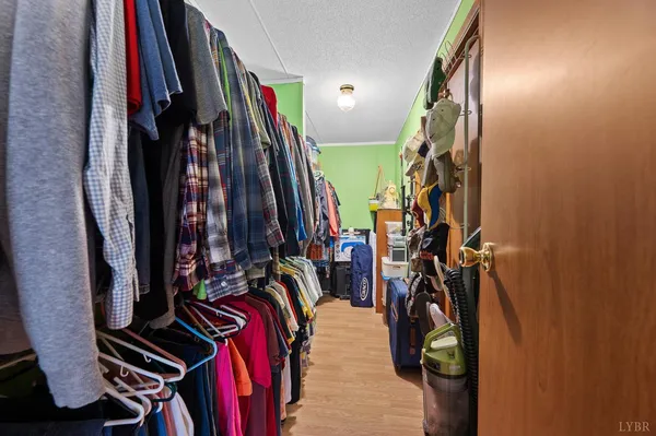 a view of walk in closet with clothes