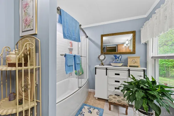 a bathroom with a bathtub sink and mirror