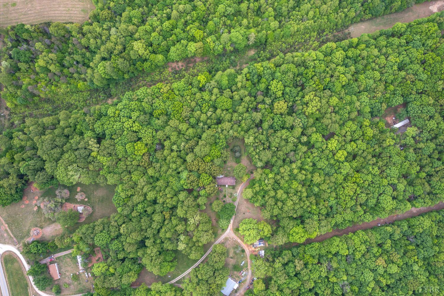 142 Micklem Lane Shipman, VA 22971 - Photo 36 of 38 a backyard of a house with lots of green space and a fountain