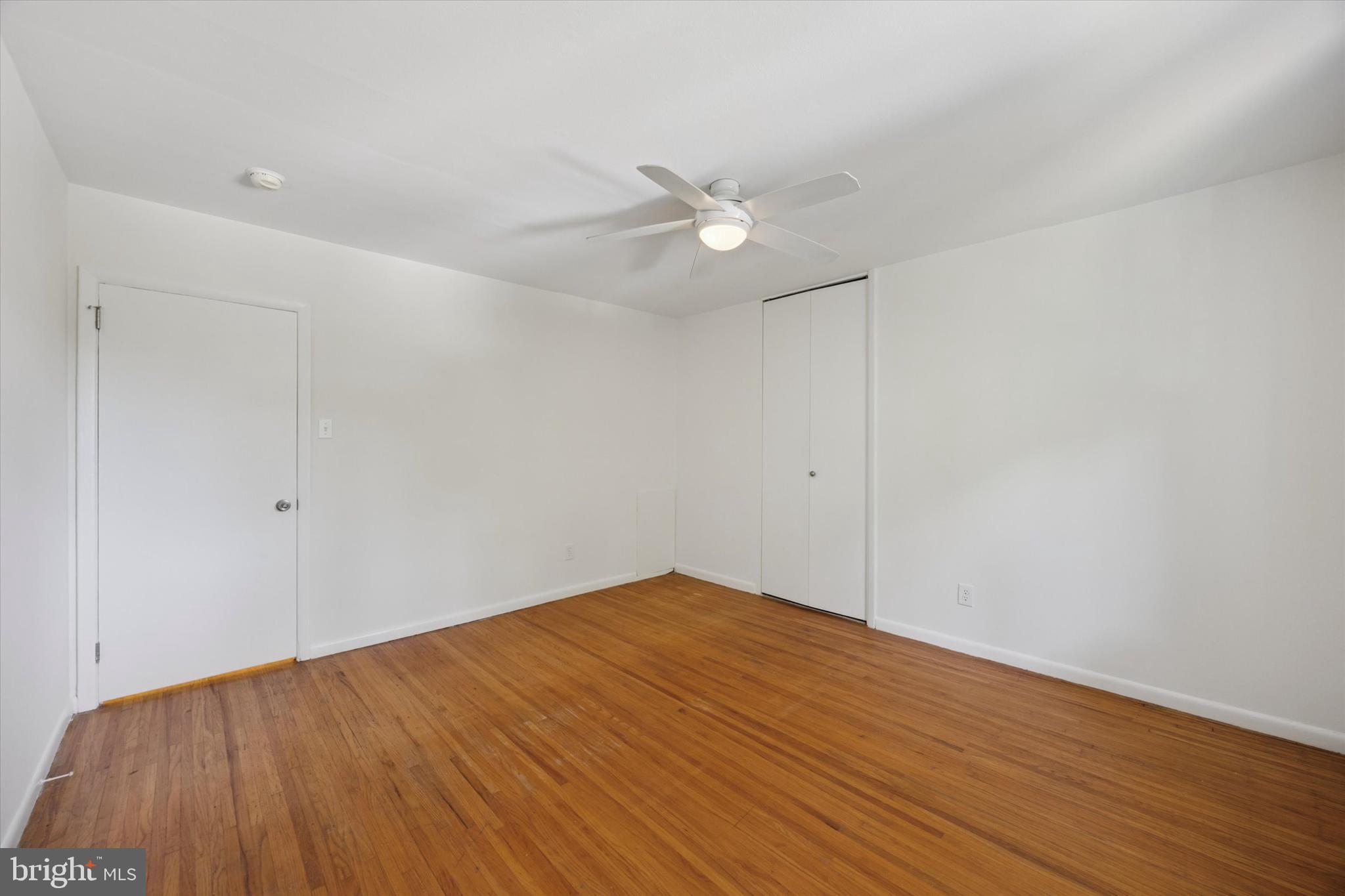 1600 Church Road, Unit A306 Wyncote, PA 19095 - Photo 12 of 15 an empty room with wooden floor and fan