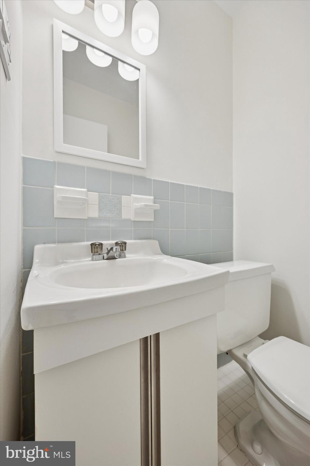1600 Church Road, Unit A306 Wyncote, PA 19095 - Photo 14 of 15 a bathroom with a sink a toilet and mirror