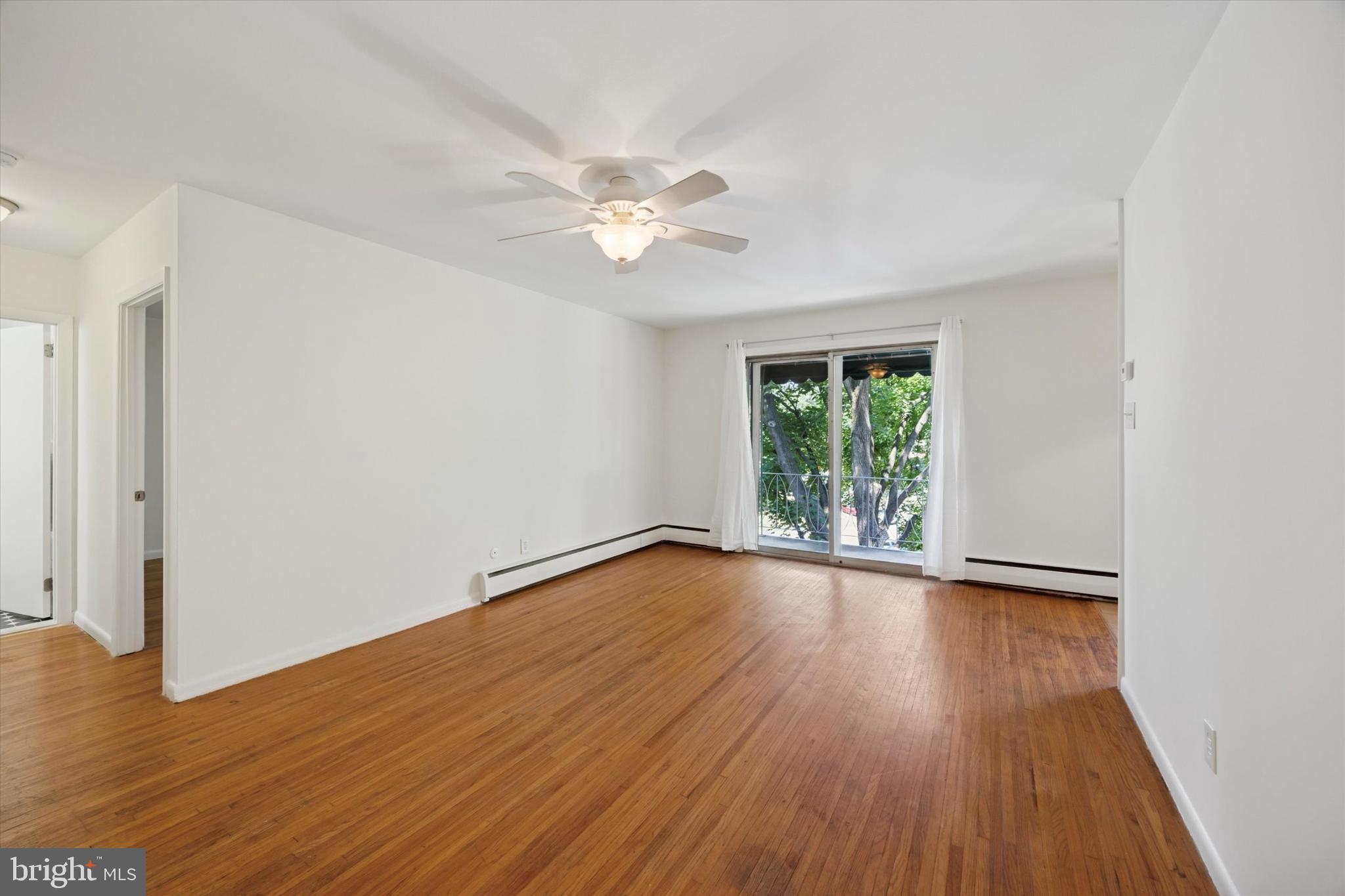 1600 Church Road, Unit A306 Wyncote, PA 19095 - Photo 3 of 15 a view of empty room with wooden floor and fan