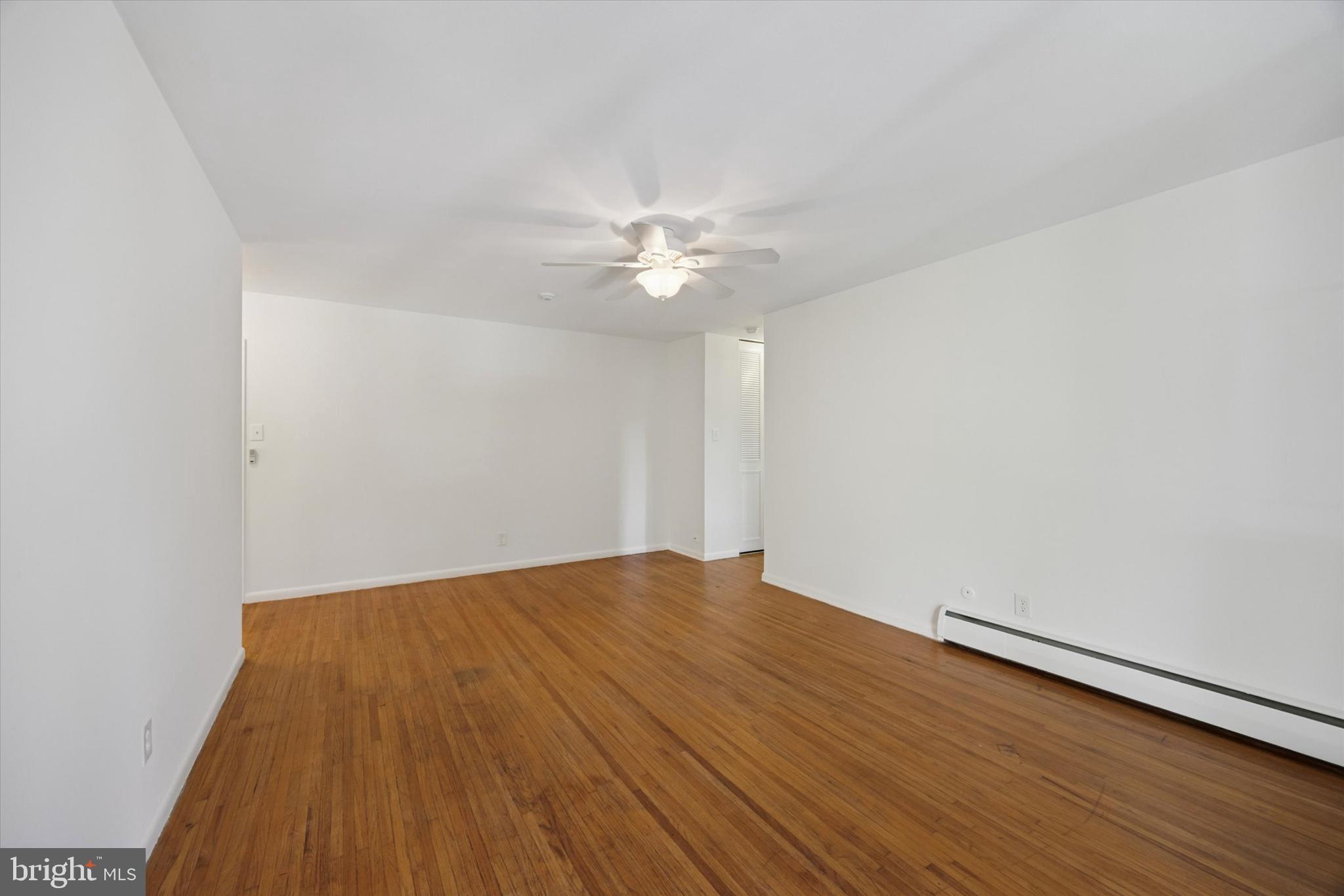 1600 Church Road, Unit A306 Wyncote, PA 19095 - Photo 5 of 15 a view of an empty room with wooden floor