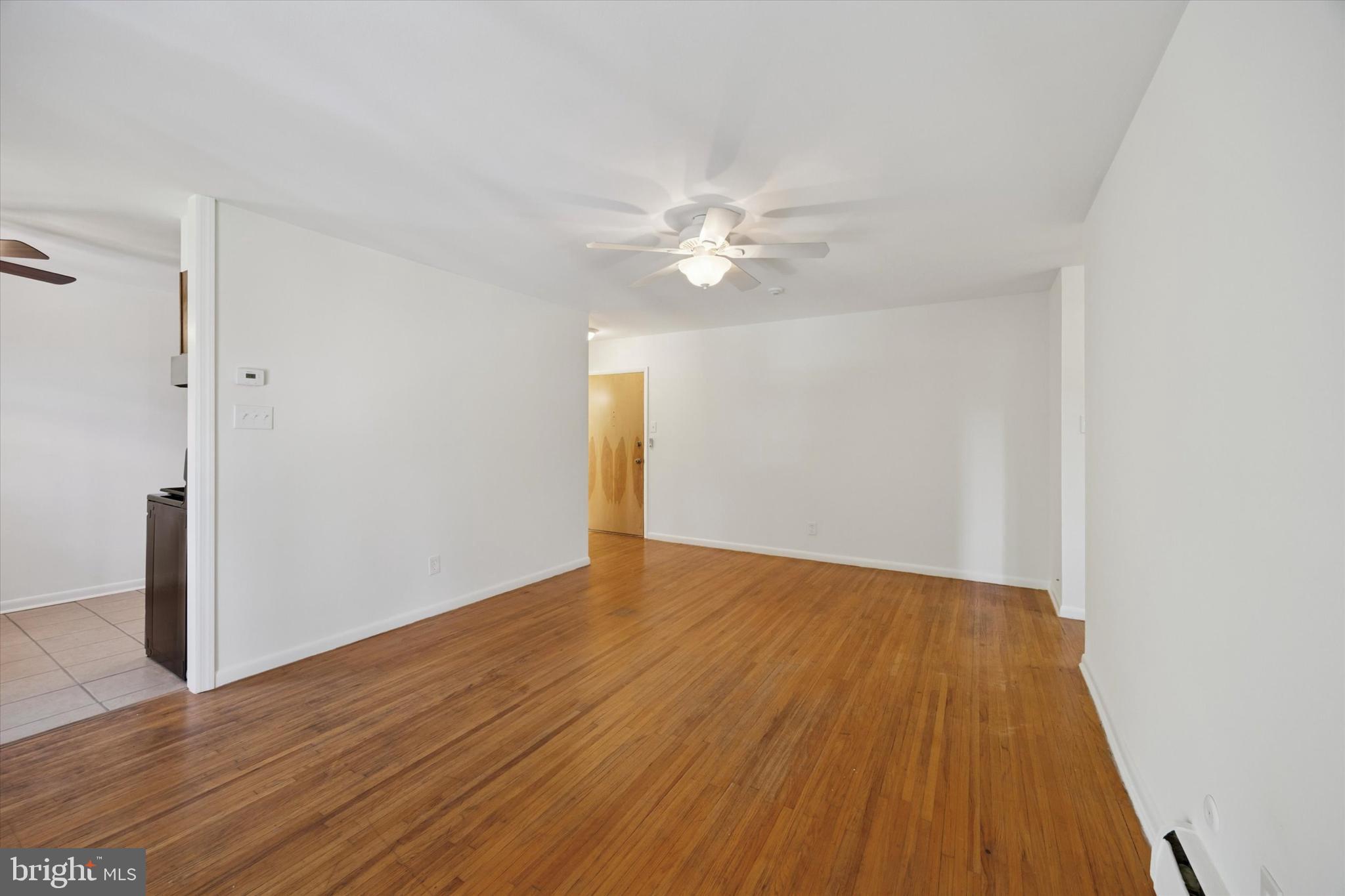 1600 Church Road, Unit A306 Wyncote, PA 19095 - Photo 6 of 15 a view of an empty room with wooden floor
