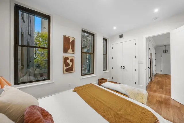 a bedroom with a bed and a closet