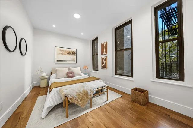 a bedroom with a bed and a painting on the wall