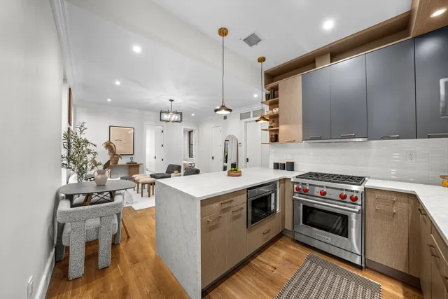 a kitchen with a sink a stove and a refrigerator