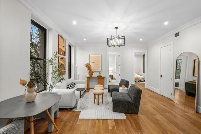 a kitchen with a stove and a wooden floor