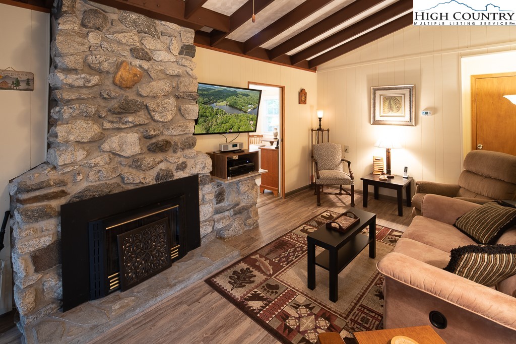 10 Overlook Road Newland, NC 28657 - Photo 13 of 50 a living room with furniture a flat screen tv and a fireplace
