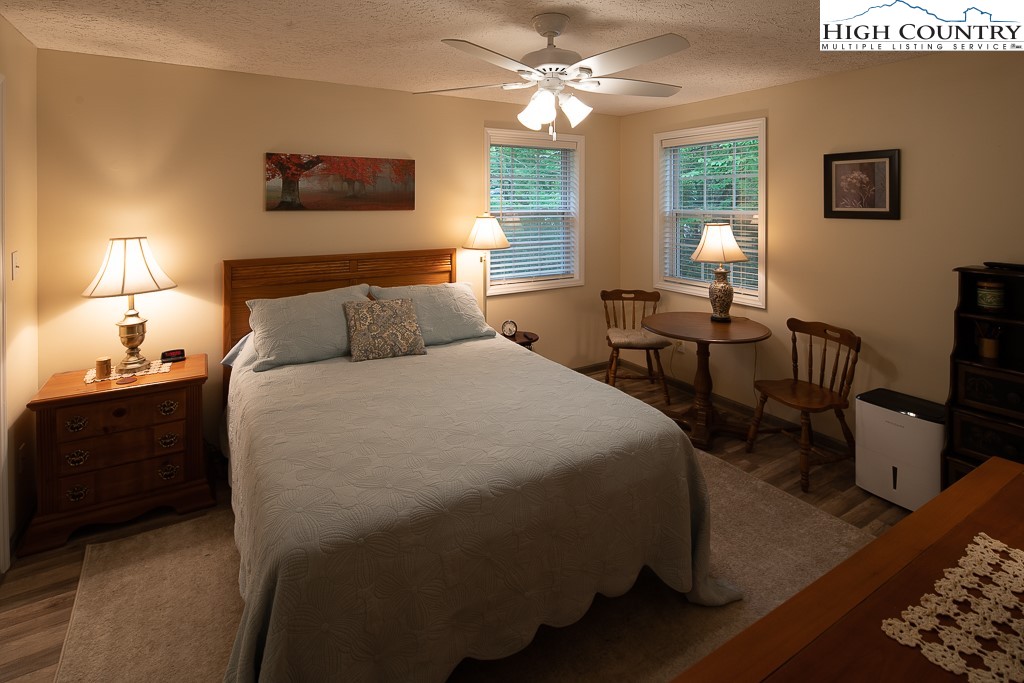10 Overlook Road Newland, NC 28657 - Photo 21 of 50 a bed room with a bed and a chandelier