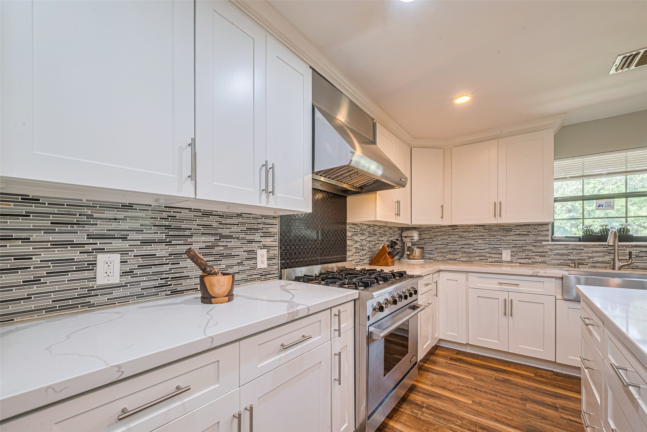 24314 Anderson Street Huffman, TX 77336 - Photo 22 of 48 a kitchen with a sink stove and cabinets