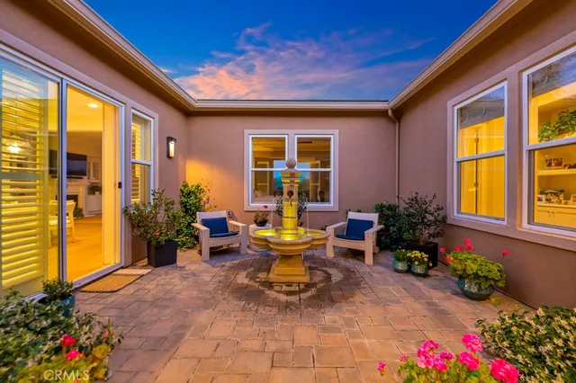 a view of a patio with chairs and potted plants