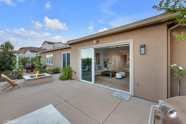 a view of a house with backyard sitting area and porch