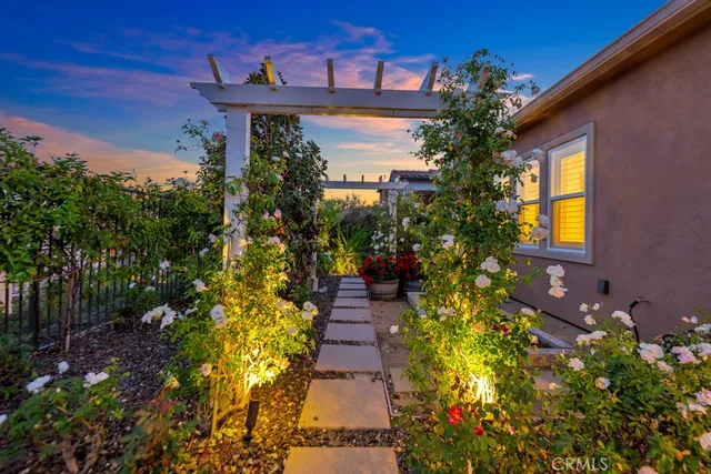 a pathway of a house with a yard
