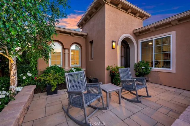 a view of a house with backyard and sitting area