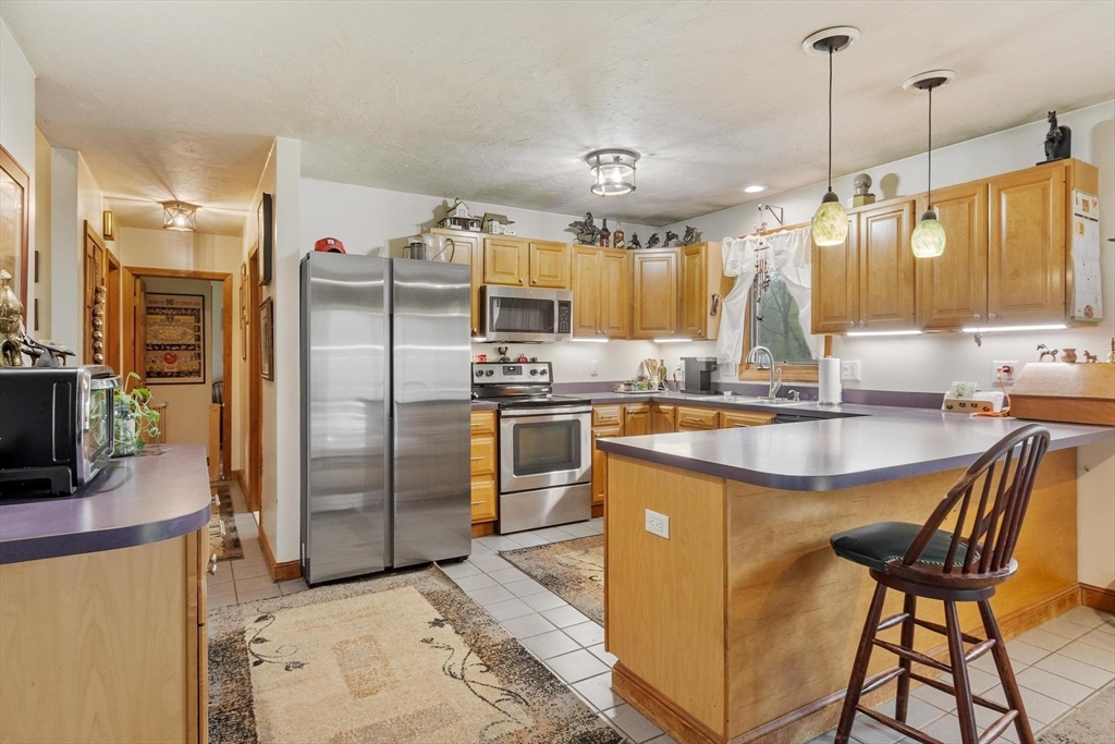 340 Ball Hill Road Princeton, MA 01541 - Photo 26 of 41 a kitchen with stainless steel appliances granite countertop a sink a stove and a refrigerator