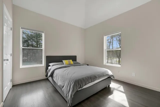 a bed sitting in a bedroom next to a window