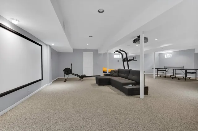 a living room with furniture gym equipment and a flat screen tv