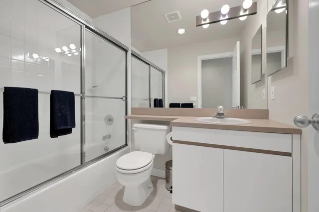 a bathroom with a toilet a sink and a mirror