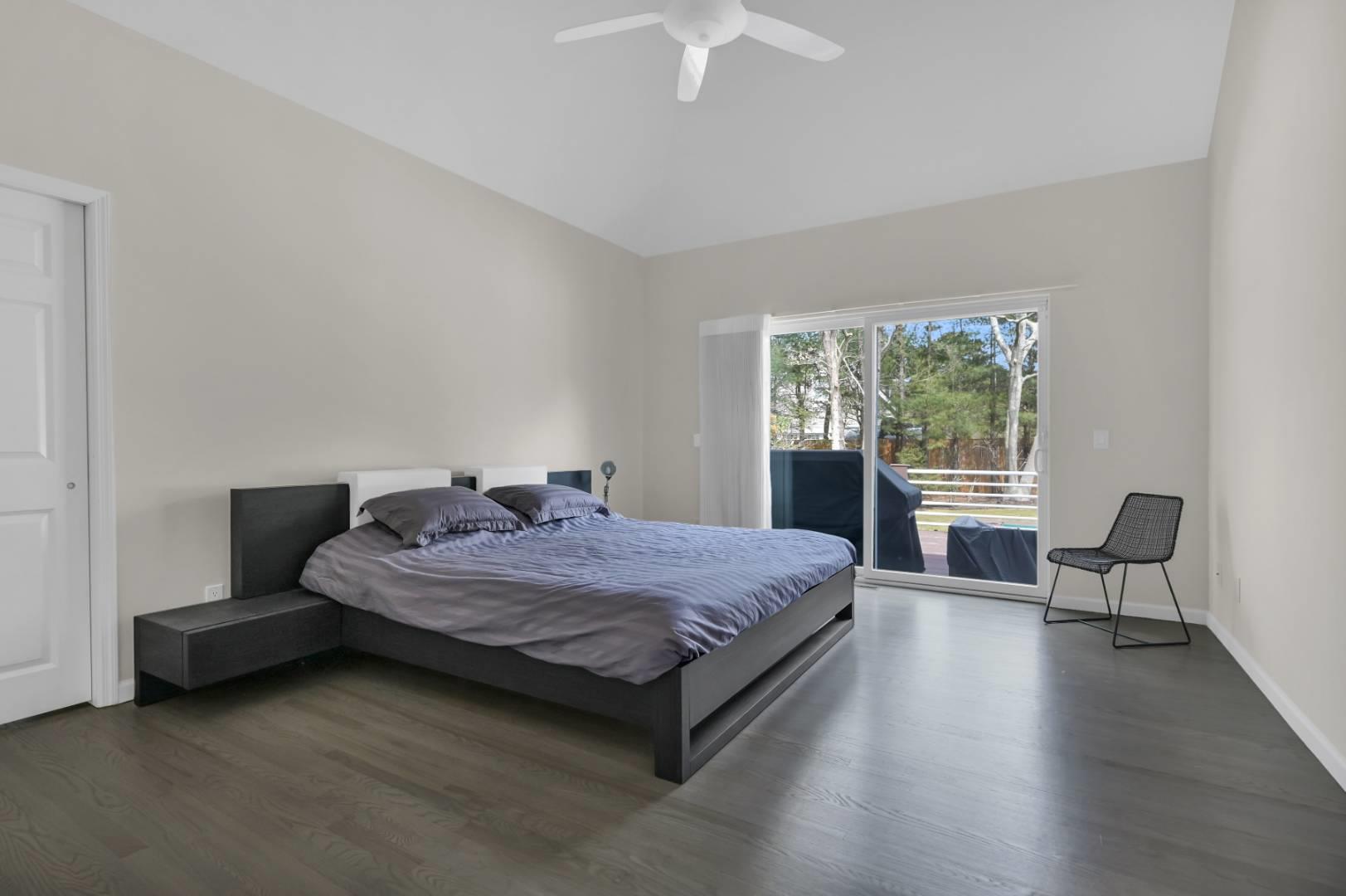 26 Lakeside Lane Westhampton, NY 11977 - Photo 9 of 24 a bedroom with a bed and a chair