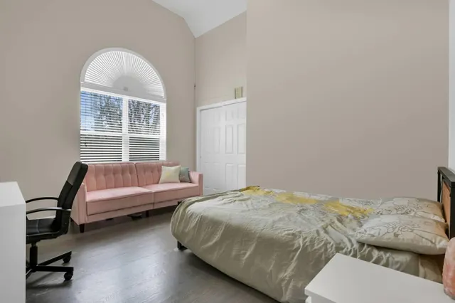 a bedroom with a bed and a window