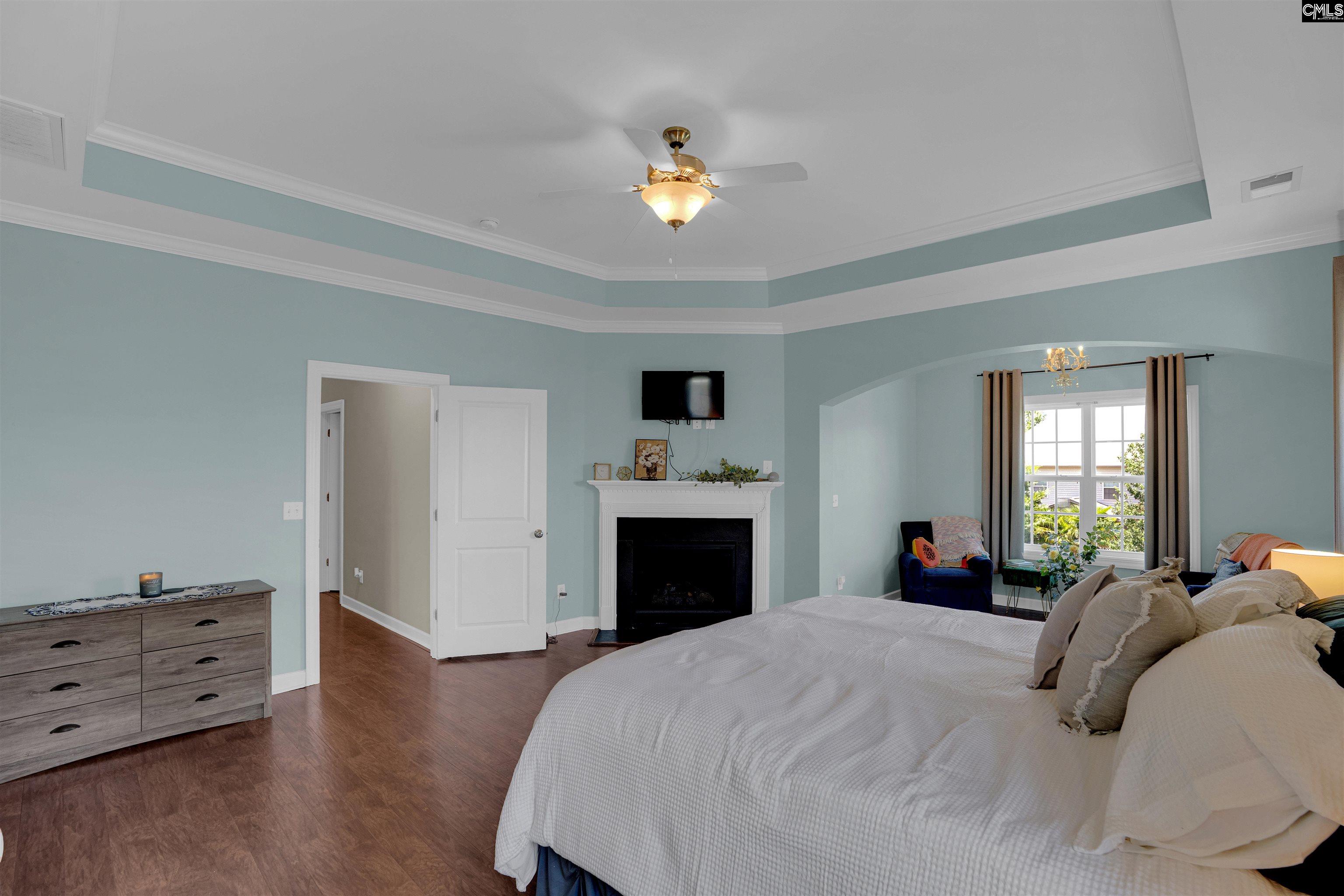 321 Asa Rose Lexington, SC 29072 - Photo 24 of 52 a bedroom with a bed and a chandelier