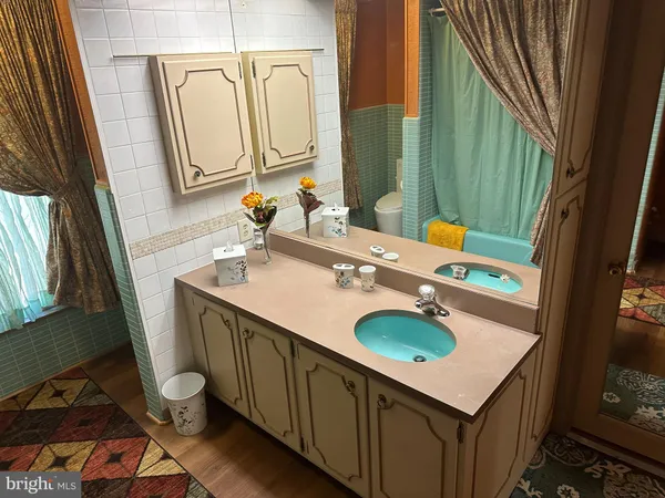 a bathroom with a sink a toilet and mirror