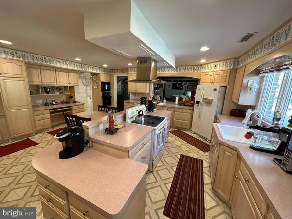 a kitchen with a stove a sink and a refrigerator