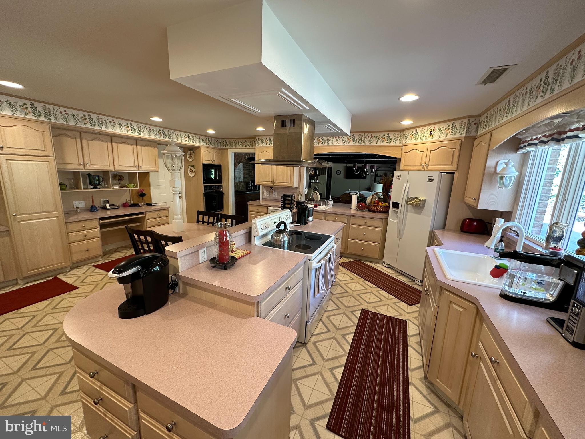 600 Glenside Road Millville, NJ 08332 - Photo 21 of 61 a kitchen with stainless steel appliances granite countertop a sink dishwasher a refrigerator a stove and a dining table with wooden floor