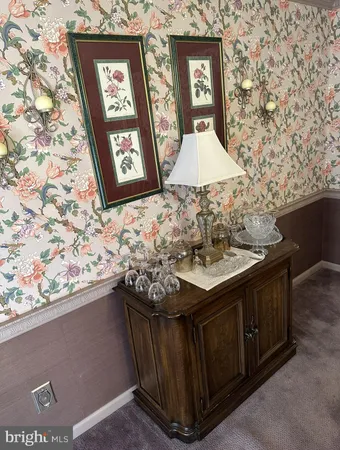 a bedroom with a bed and dresser with mirror