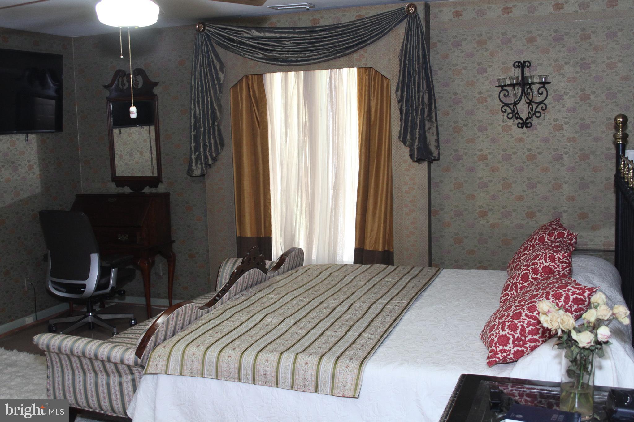 600 Glenside Road Millville, NJ 08332 - Photo 32 of 61 a bedroom with a bed and dresser with mirror