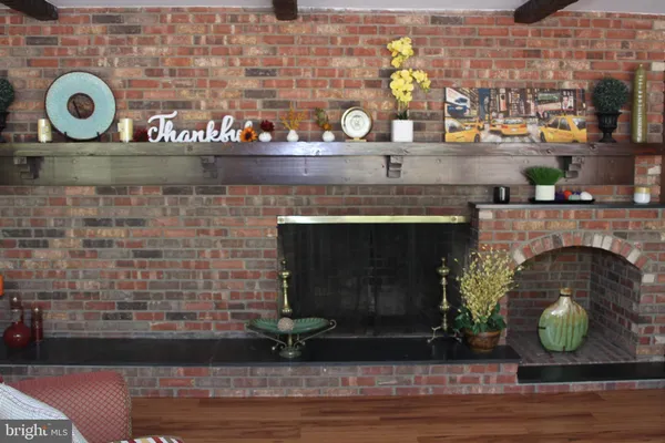 a dining table with a large window and chairs