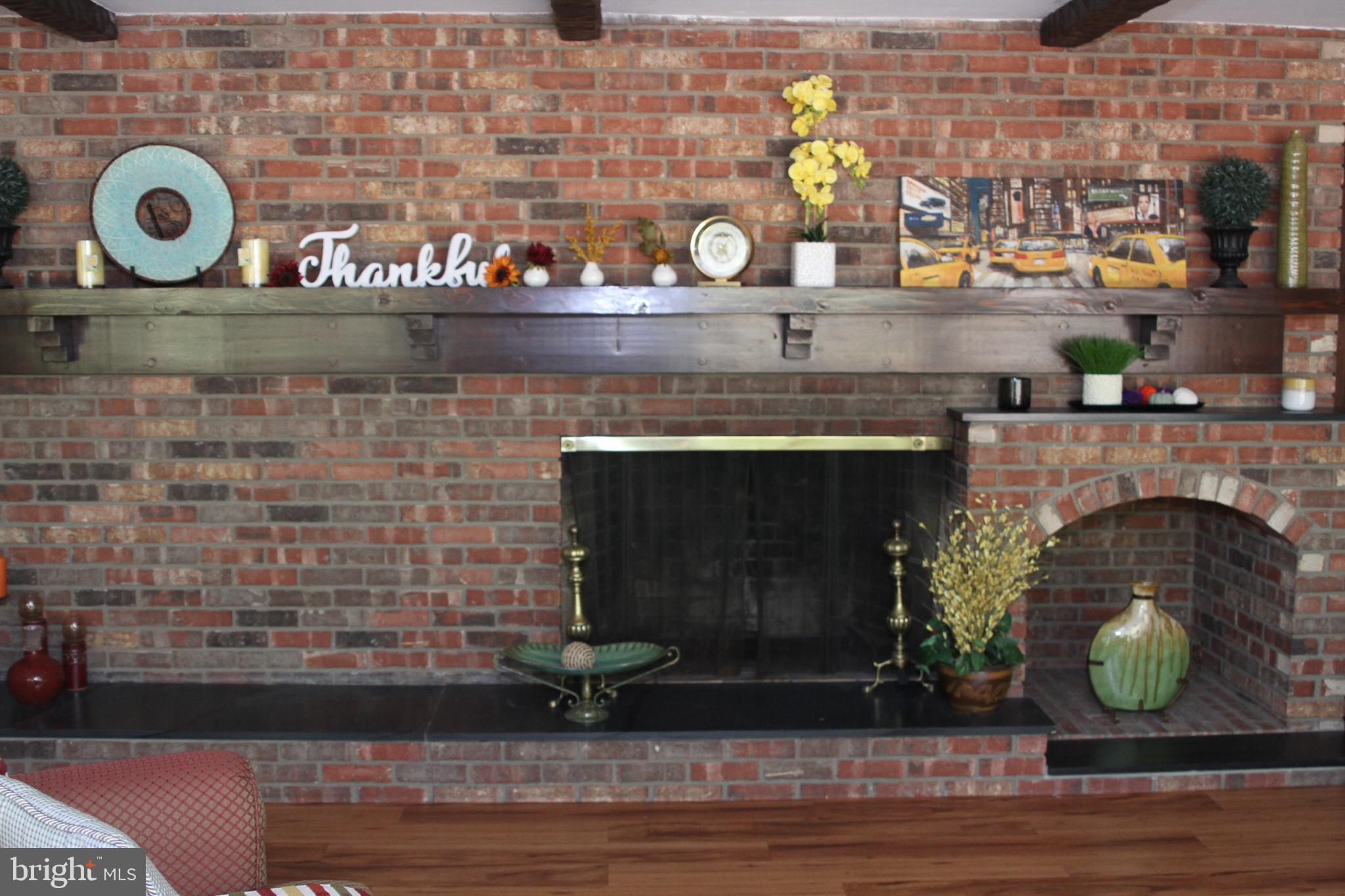 600 Glenside Road Millville, NJ 08332 - Photo 35 of 61 a fireplace with a clock on top of it