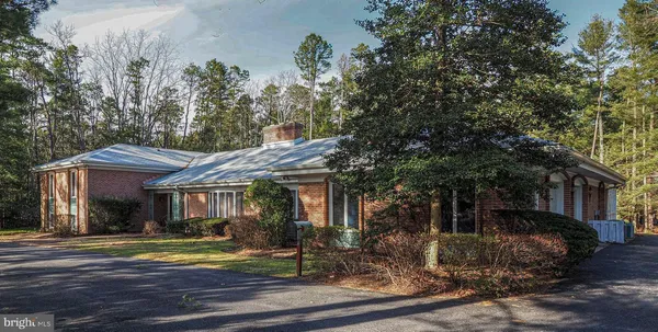 a front view of a house with a yard table and chairs