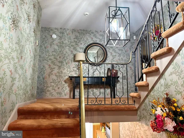 a view of entryway dining room and hall with wooden floor