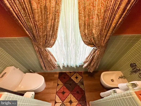 a bathroom with a toilet sink and mirror