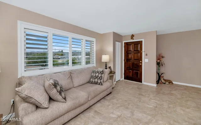 a living room with furniture and a large window