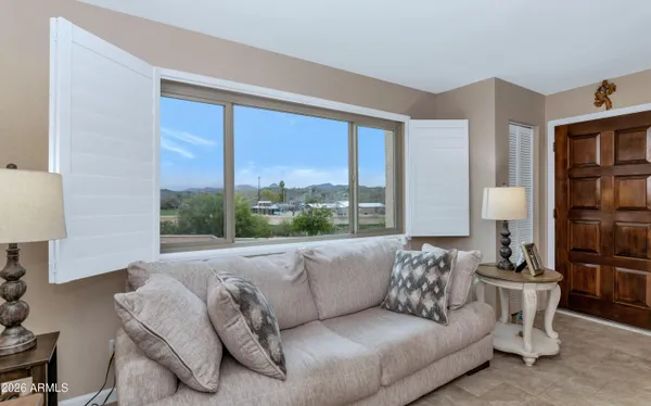 a living room with furniture and a large window