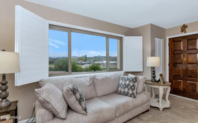 a living room with furniture and a large window