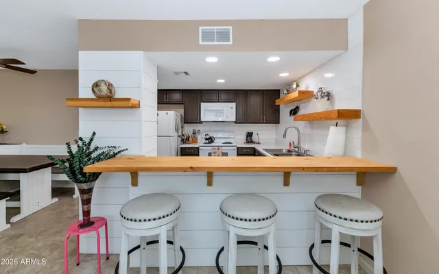 a kitchen with stainless steel appliances a sink and a refrigerator