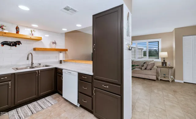 a view of kitchen with stainless steel appliances kitchen island granite countertop a refrigerator and a sink