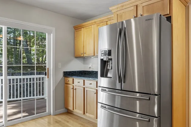 a metallic refrigerator freezer sitting in a kitchen