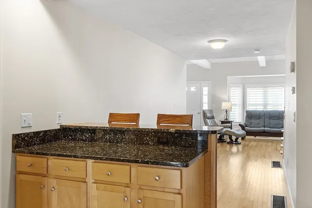 a kitchen with granite countertop a sink and cabinets