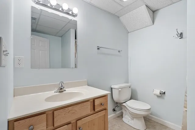 a bathroom with a sink a toilet and mirror