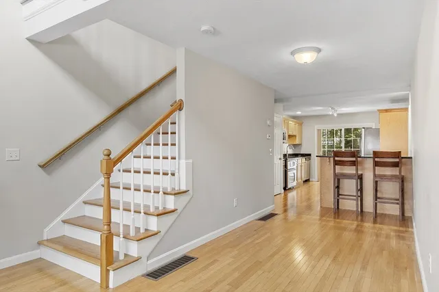 a view of entryway with dining room and wooden floor