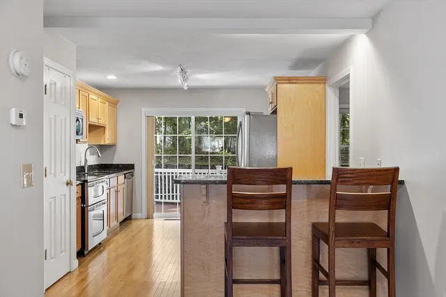 a kitchen with a table chairs refrigerator and cabinets