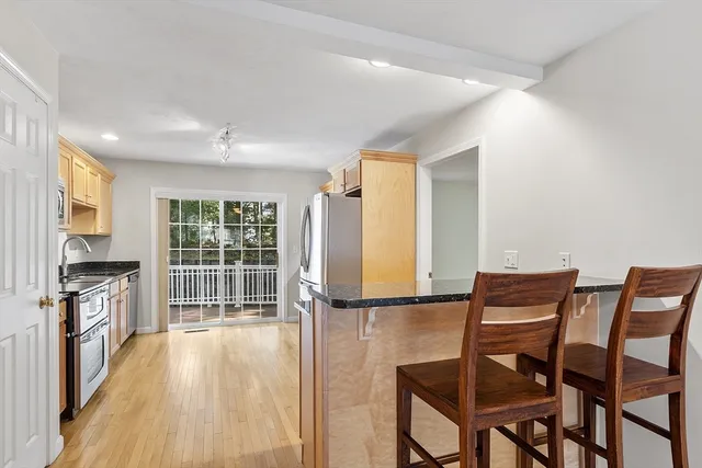 a view of a kitchen with furniture and wooden floor