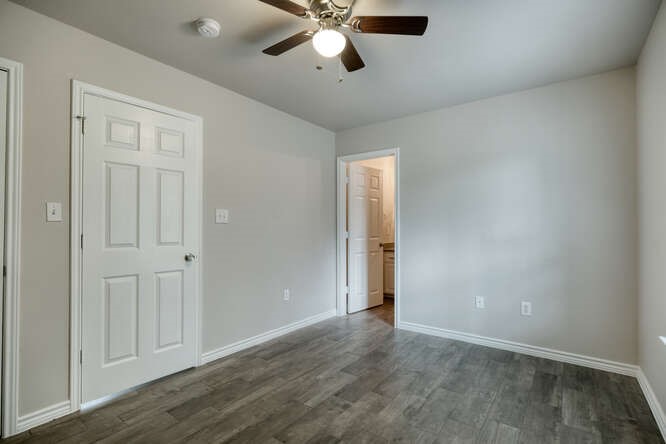 107 Castleberry Court, Unit D Bertram, TX 78605 - Photo 10 of 13 Spare room featuring dark hardwood / wood-style floors and ceiling fan